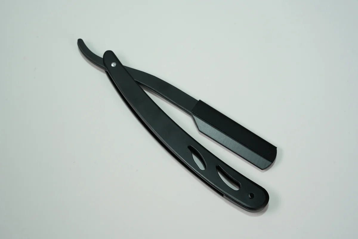Black folding straight razor with ergonomic handle for precise shaving and grooming