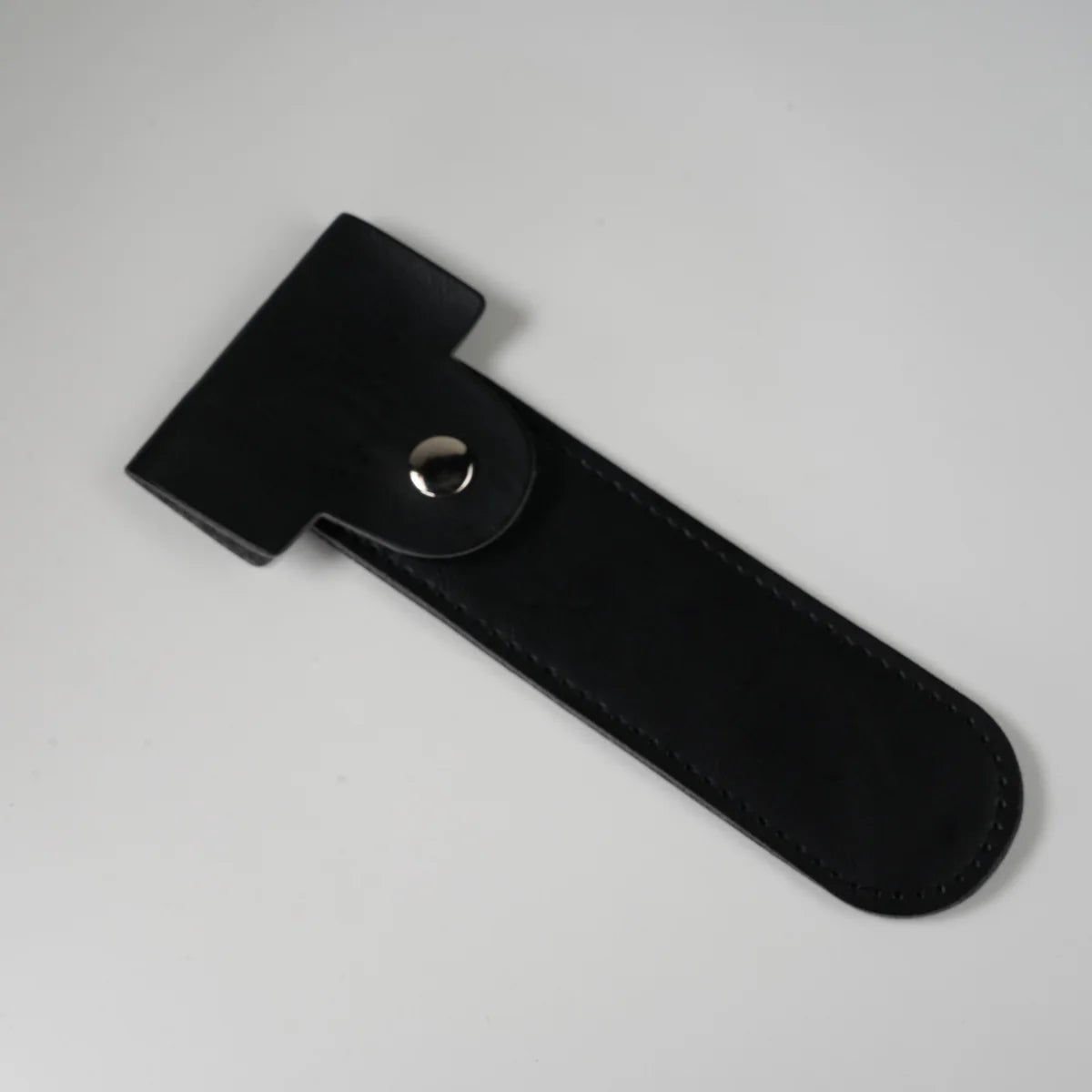 Black leather watch strap with silver snap button closure and stitched edges for secure fit