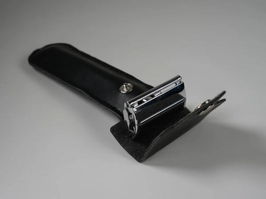 Chrome double-edge safety razor in black leather snap case for travel and grooming
