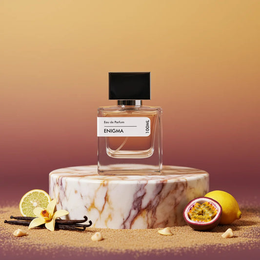 Enigma Eau de Parfum 100ml bottle on marble stand with vanilla, lemon, passion fruit, and sugar