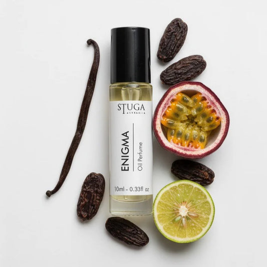 10ml Stuga Enigma oil perfume bottle with vanilla bean, tonka beans, passion fruit, and lime on white background