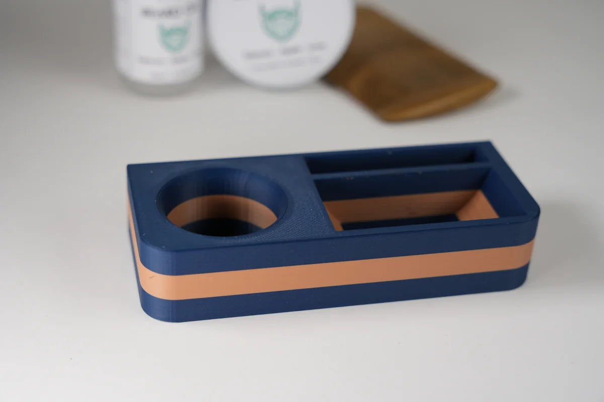 Navy blue and brown rectangular desk organizer with circular and rectangular compartments for office supplies
