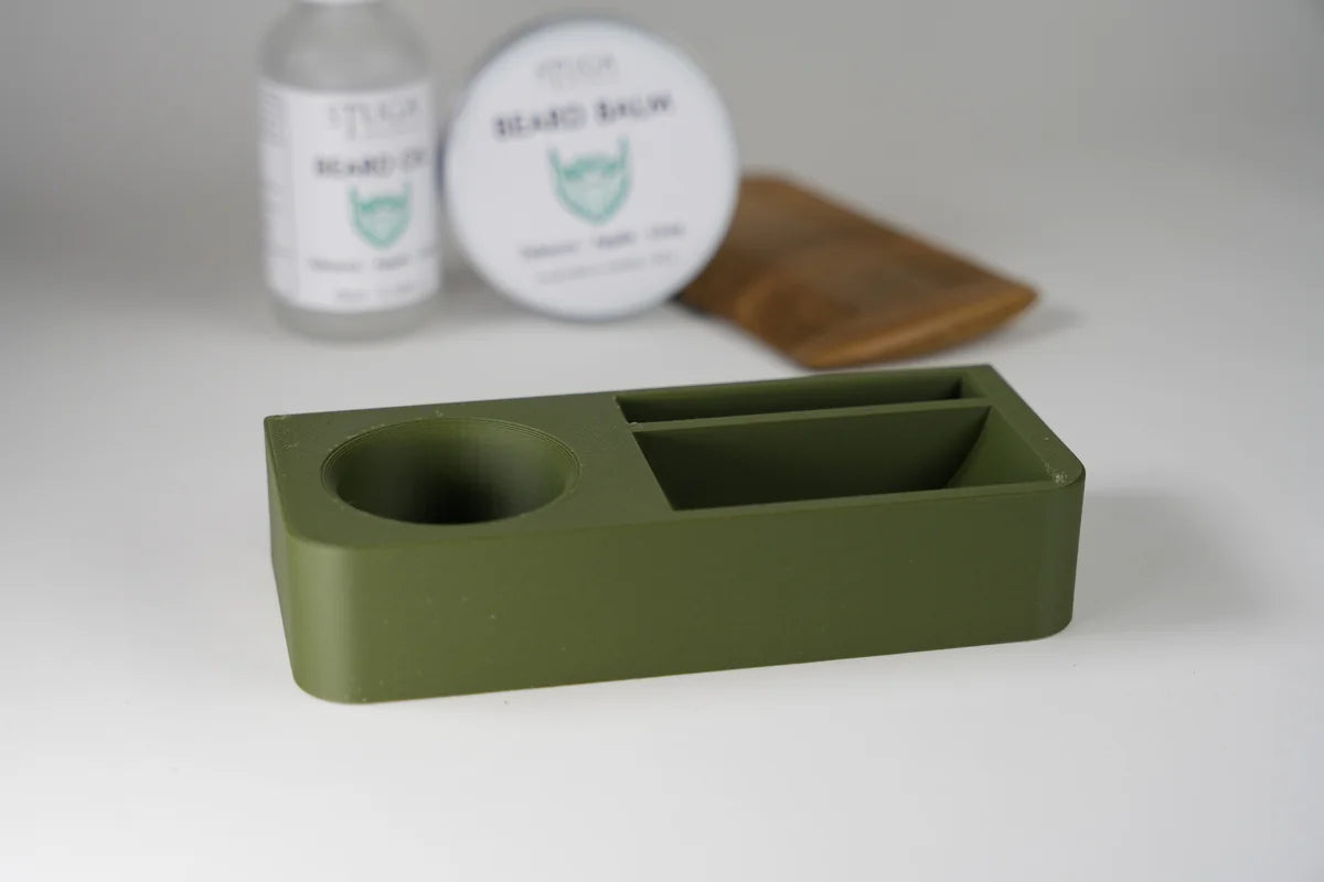 Olive green plastic beard trim tray with compartments for catching hair clippings during grooming