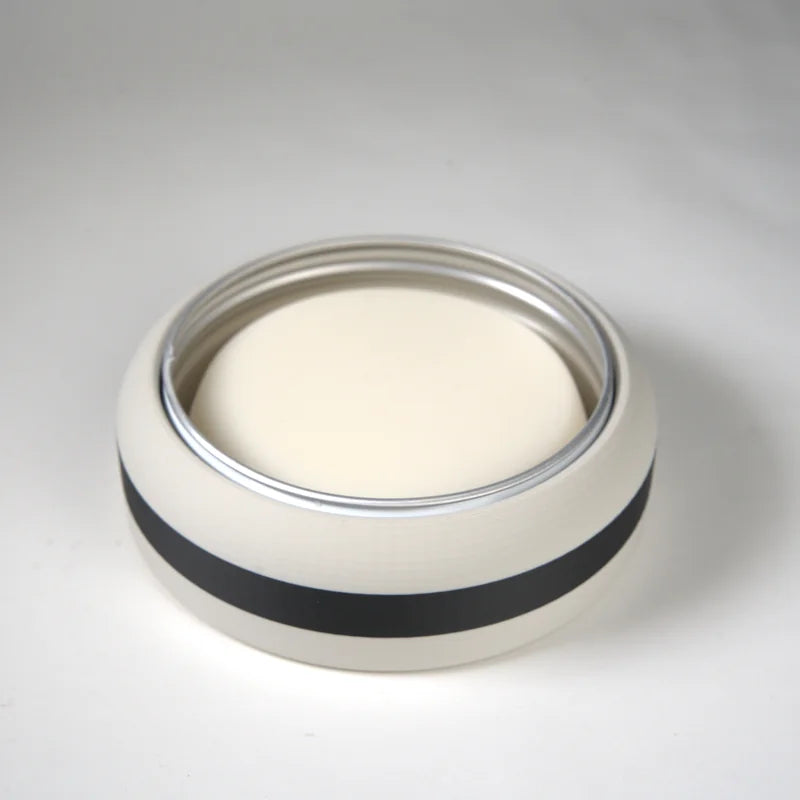 Round ceramic candle holder with white body and black horizontal stripe, metal rim, suitable for home decor