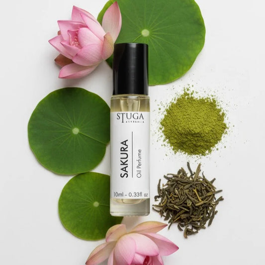 10ml bottle of Stuga Australia Sakura oil perfume with lotus flowers, green tea powder, and dried tea leaves