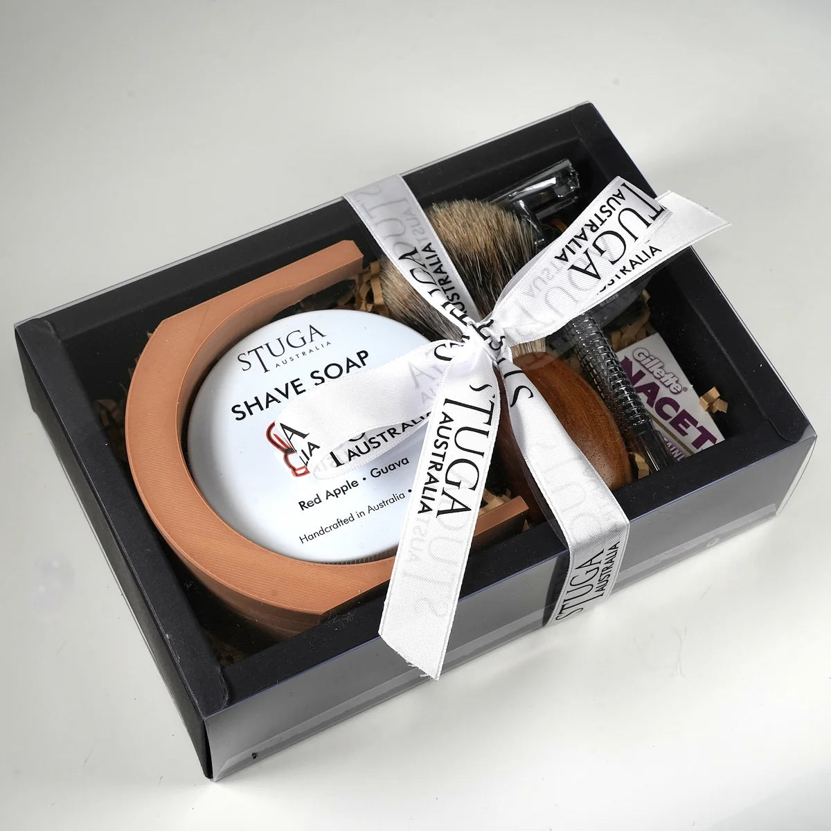 Stuga Australia shaving set with red apple guava shave soap, wooden brush, metal razor, and Gillette razor blades in black gi