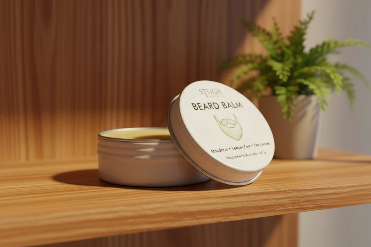 Stuga Beard Balm with mandarin, lemon zest, and tea tree, in a white tin on a wooden shelf.