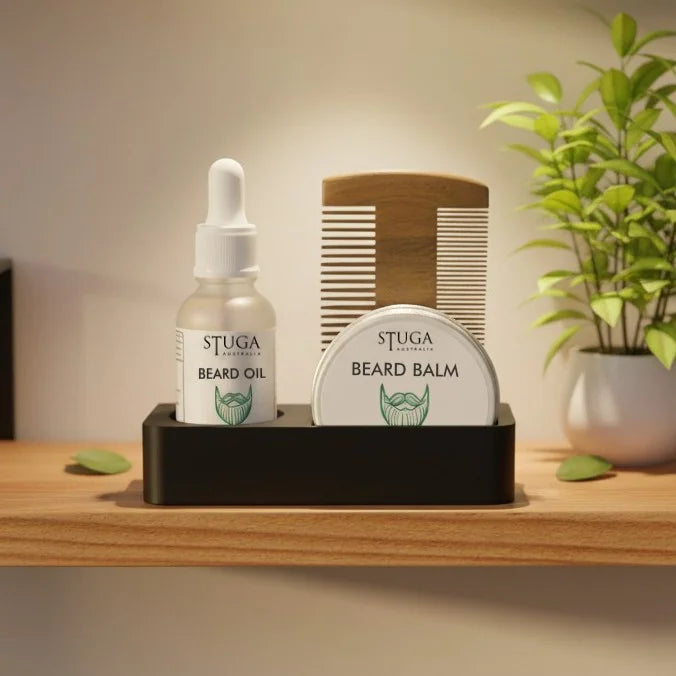 Stuga Australia beard grooming kit with beard oil, balm, and wooden comb in a black holder on a wooden shelf.
