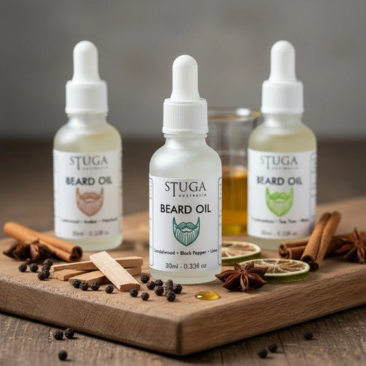Three bottles of Stuga Australia beard oil in sandalwood, black pepper, and lime scents on a wooden board with spices.
