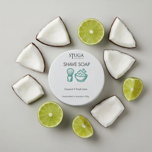 Stuga Australia shave soap with coconut and fresh lime, handcrafted, 80g, surrounded by coconut pieces and lime halves.