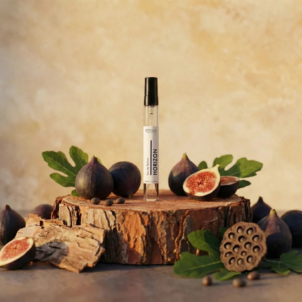 Stuga Horizon Eau de Parfum 10ml travel spray in clear glass vial with black cap, styled with fresh figs and wood