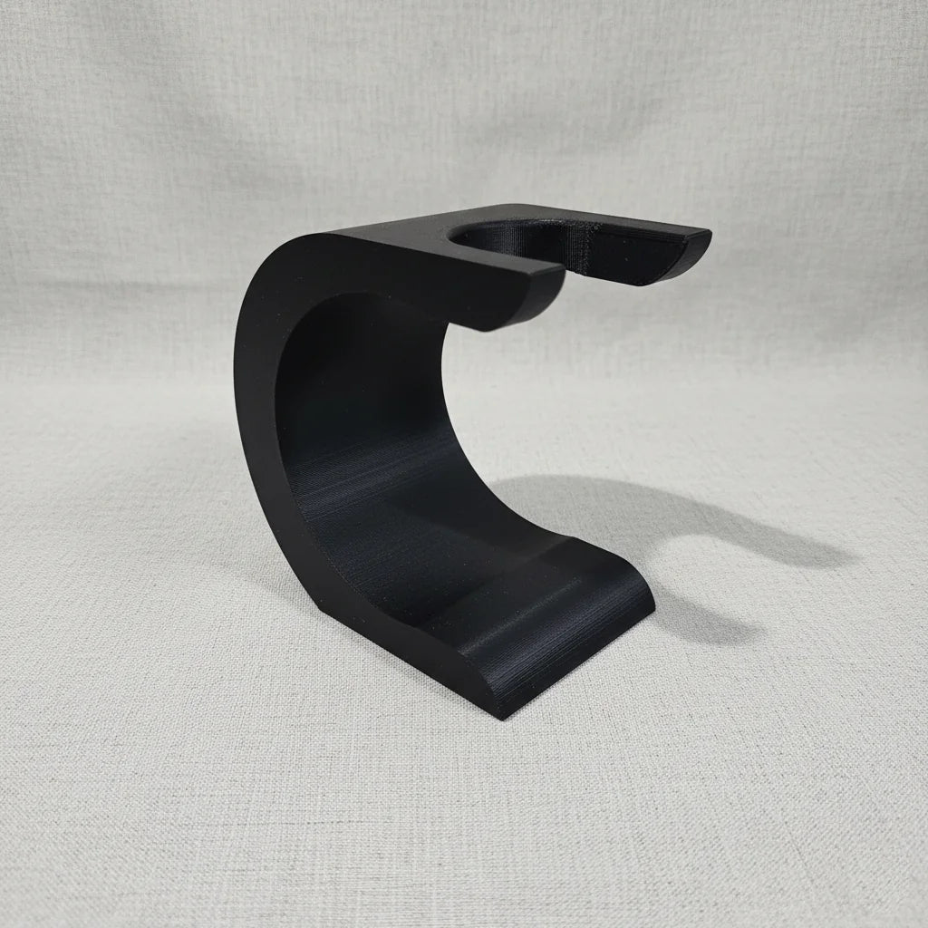 Black Stuga Wave shaving brush stand, curved design, for drying and displaying shaving brushes.