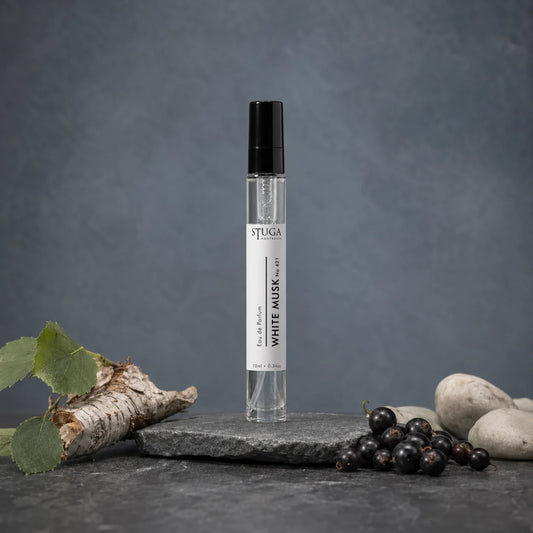 Stuga White Musk No. 421 white musk perfume, 10ml eau de parfum spray bottle on a slate slab, with silver birch bark, fresh blackcurrants and smooth pale stones.