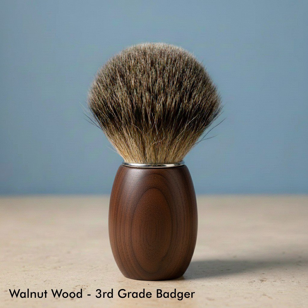 Close-up of a shaving brush with a dark brown walnut wood handle and soft, light brown 3rd grade badger bristles.