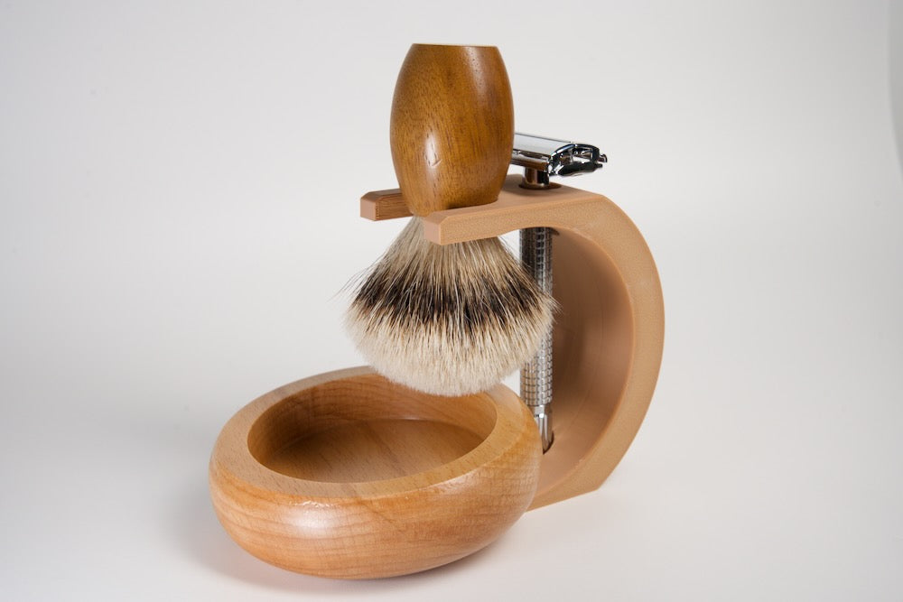 Wooden shaving brush with stand and bowl on a white background