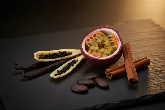 Vanilla pods, passionfruit, tonka beans, and cinnamon on dark slate — vanilla perfume guide