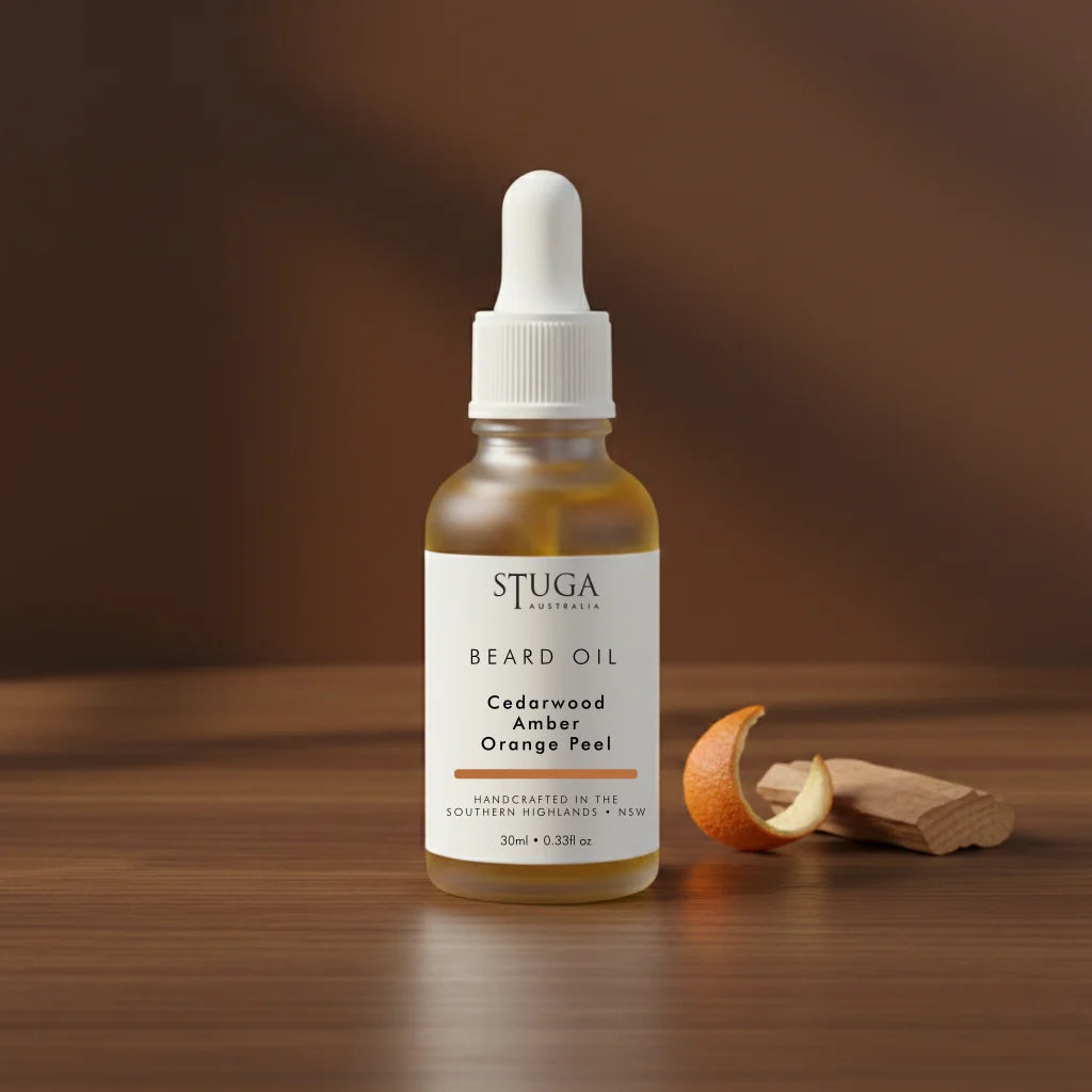 Stuga Australia 30ml beard oil dropper bottle in cedarwood, amber, and orange peel scent on wooden surface