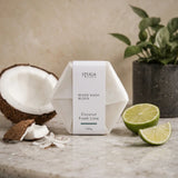 Stuga Australia Beard Wash Block, natural shampoo bar scented with coconut and fresh lime, 100g, with fresh coconut and lime on a stone benchtop.