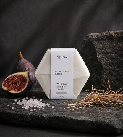 Stuga Australia Beard Wash Block, natural shampoo bar scented with wild fig, sea salt and vetiver, 100g, with fresh figs and vetiver root on dark stone.