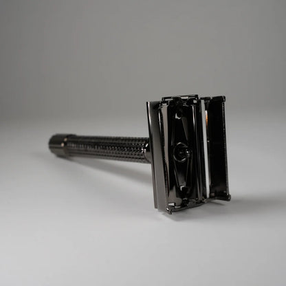 Black metal double edge safety razor with textured handle for precise shaving