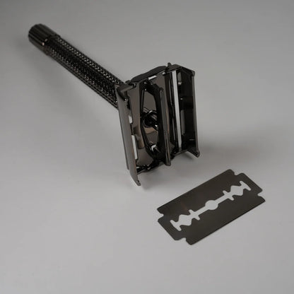 Black metal safety razor with textured handle and detachable double-edge blade for precise shaving