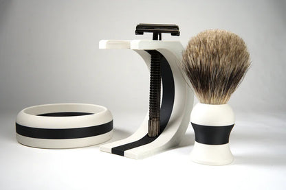 Black and white shaving set with badger hair brush, razor, and matching stand and bowl for grooming