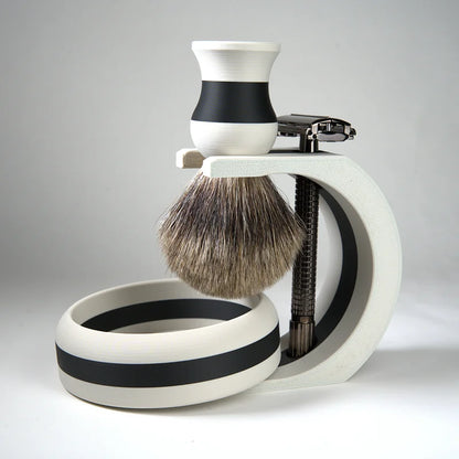 Black and white shaving set with badger hair brush, safety razor, and matching bowl on stand