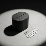 Stuga Blade Bank sealed matte charcoal razor blade disposal case on concrete