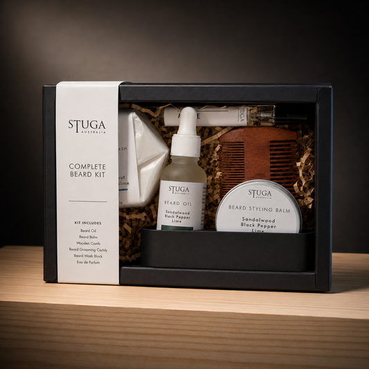 Stuga Complete Beard Kit gift box — beard wash block, beard oil, styling balm, wooden comb, grooming caddy and a matched 10ml eau de parfum, scent-matched in Sandalwood, Black Pepper & Lime. Handmade in Australia.