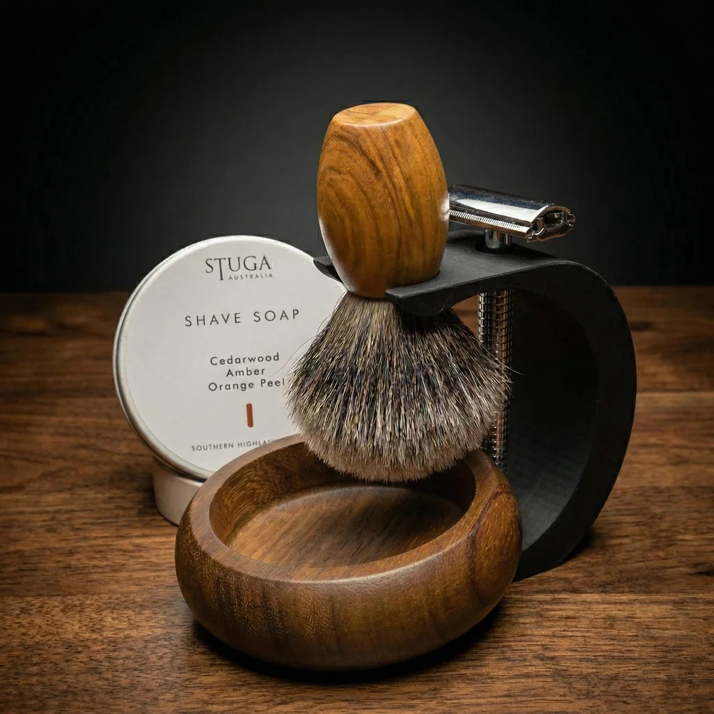 Stuga Australia complete shaving kit with olive wood shaving brush, safety razor, black metal stand, wooden bowl, and cedarwood shave soap