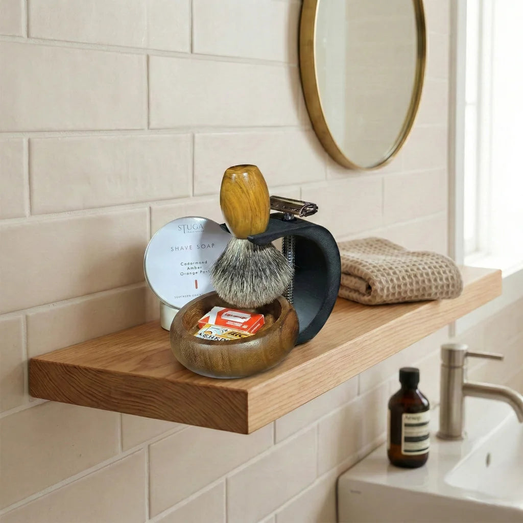 Complete shaving kit with wooden bowl, badger hair brush, safety razor on dark metal stand, and Stuga shave soap tin