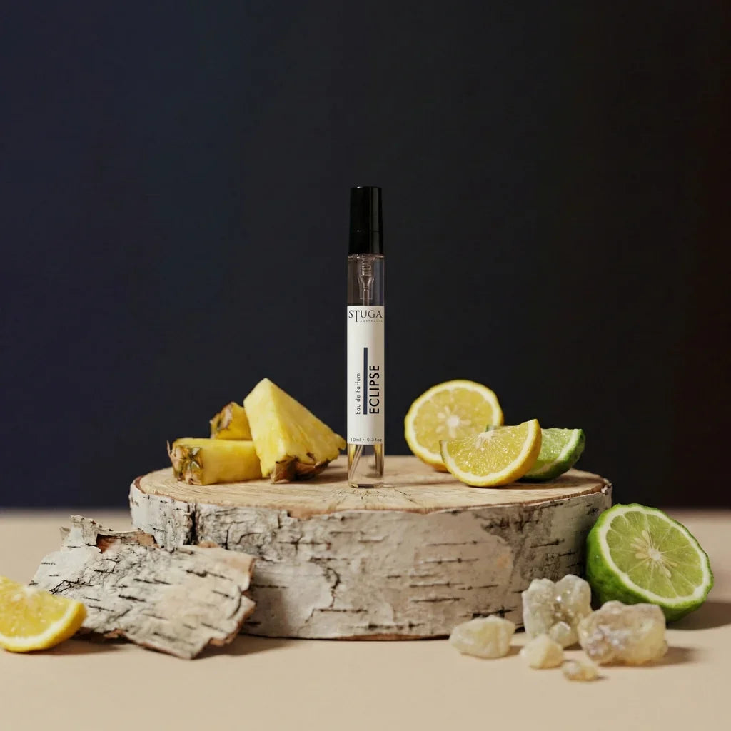 Stuga Australia Eclipse Eau de Parfum 10ml travel spray with black cap on birch wood round with citrus and pineapple