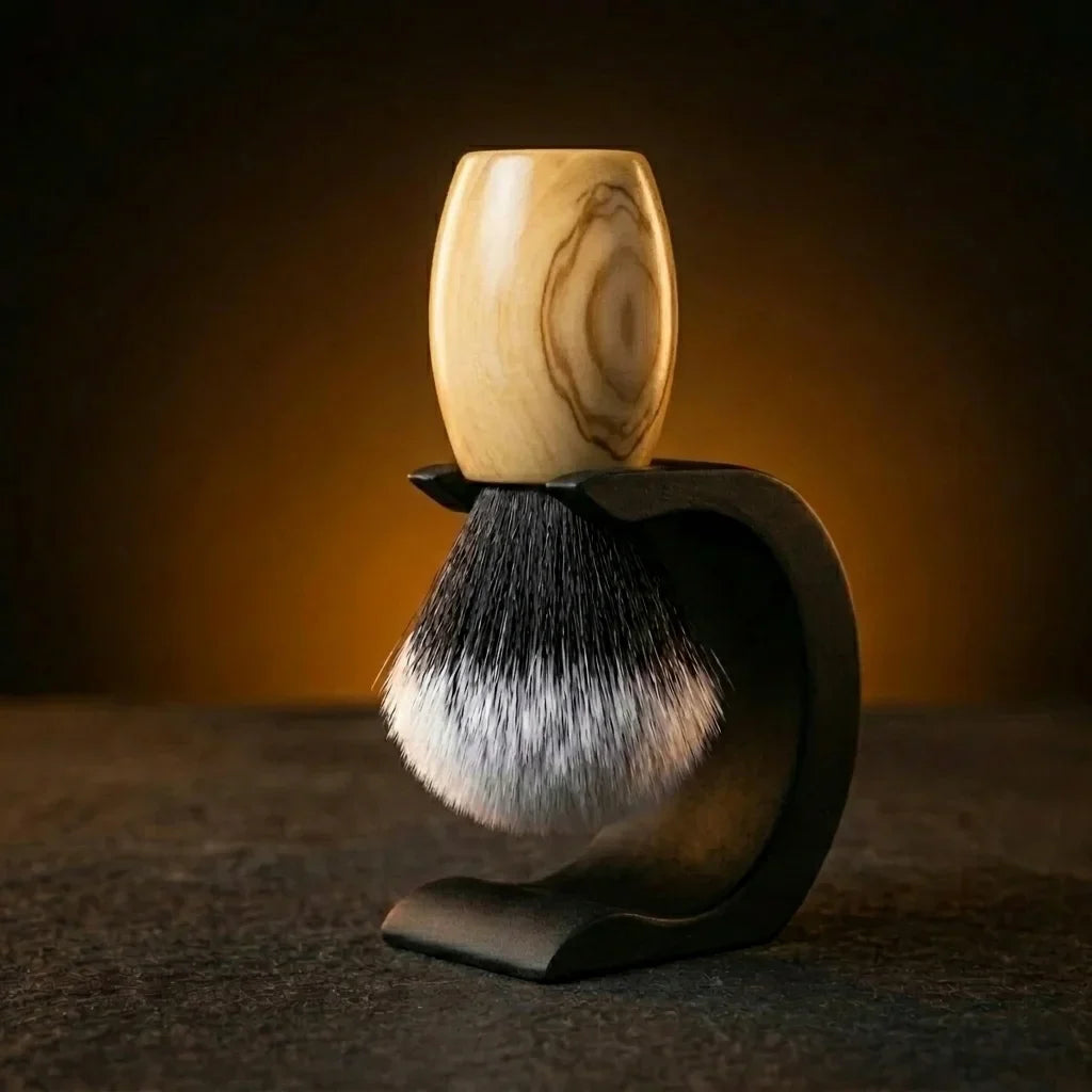 Essentials badger shaving brush with hand-carved Olive Wood timber handle on Wave stand