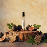 Stuga Horizon Eau de Parfum 10ml travel spray in clear glass vial with black cap, styled with fresh figs and wood