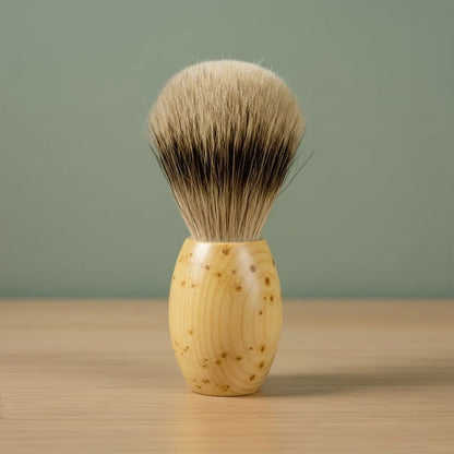 2nd grade badger bristle shaving brush with a light-colored, spotted huon pine wood handle.