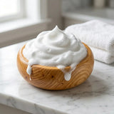 Huon Pine shaving bowl overflowing with rich shaving lather on marble bathroom countertop
