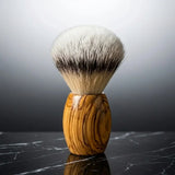 Luxury silver tip badger shaving brush with olive wood handle by Stuga on black marble
