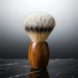 Luxury silver tip badger shaving brush with teak wood handle by Stuga on black marble