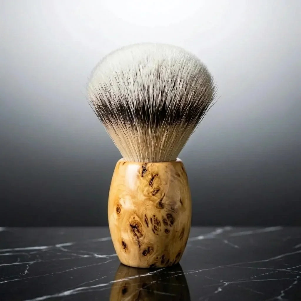 Luxury silver tip badger shaving brush with wild grain Huon Pine handle by Stuga on black marble