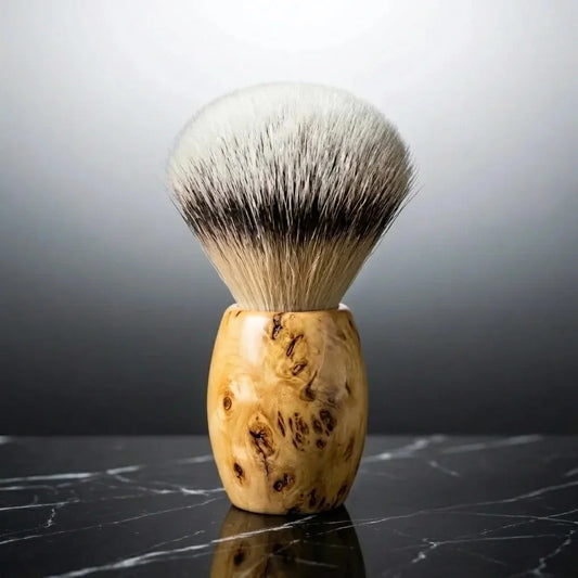 Luxury silver tip badger shaving brush with wild grain Huon Pine handle by Stuga on black marble