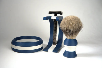 Navy blue and white striped shaving set with badger hair brush, razor, and matching bowl on white background