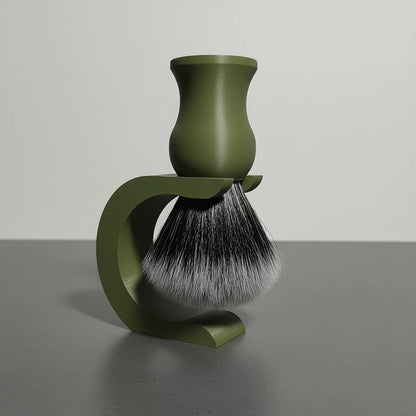 Olive green shaving brush with black and white synthetic bristles, resting on a matching olive green stand.