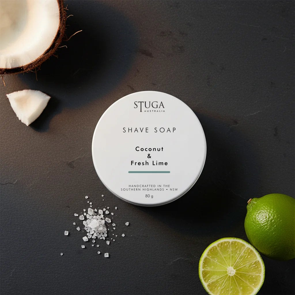 Stuga Australia Coconut & Fresh Lime shave soap in a white 80g tin on a dark slate background with coconut and lime