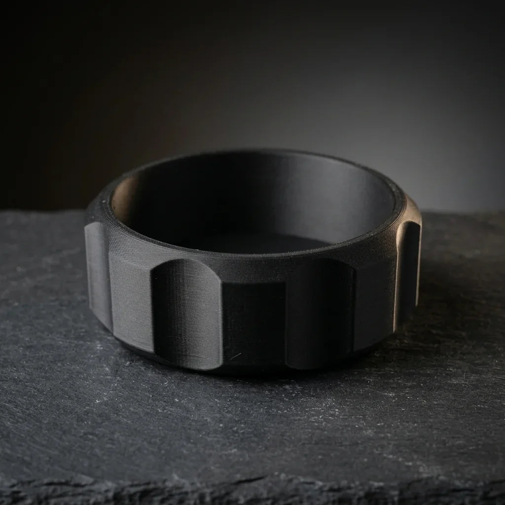 Faceted black shaving bowl with ridged grip sides on dark slate, wide lathering well for shave soap