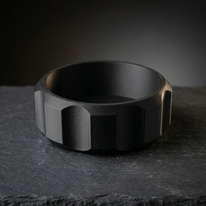 Faceted black shaving bowl with ridged grip sides on dark slate, wide lathering well for shave soap