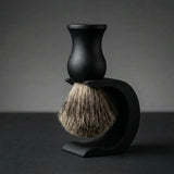 Essentials badger shaving brush with matte black polymer handle on a black Wave stand, Australian made by Stuga