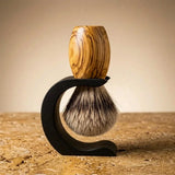 Premium badger shaving brush with handturned olive wood handle on a black stand, Australian made by Stuga