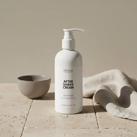 Stuga Australia After Shave Cream in a white pump bottle, 250g, next to a small grey bowl and linen cloth.