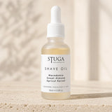 30ml Stuga Australian shave oil in a frosted glass dropper bottle on warm stone