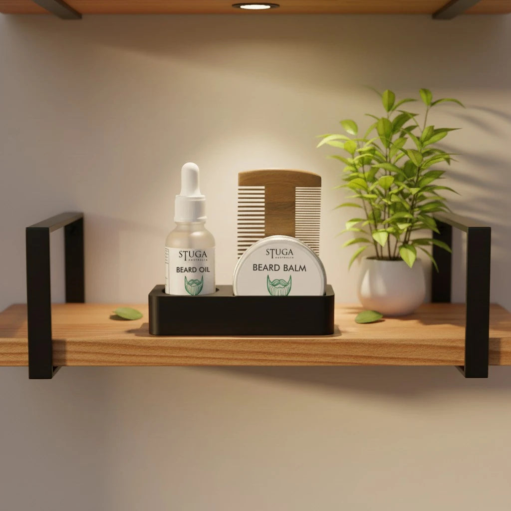 Stuga Australia beard grooming kit with oil, balm, and comb on a wooden shelf with a small plant.